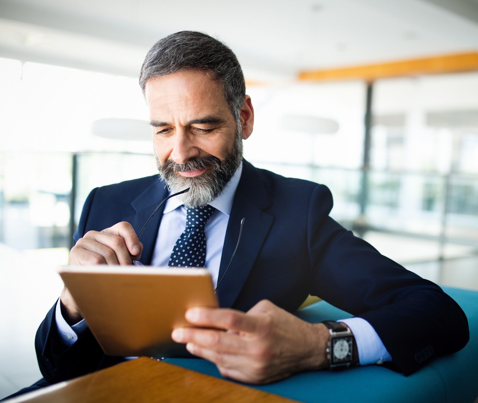 Elegant business multitasking multimedia man using devices