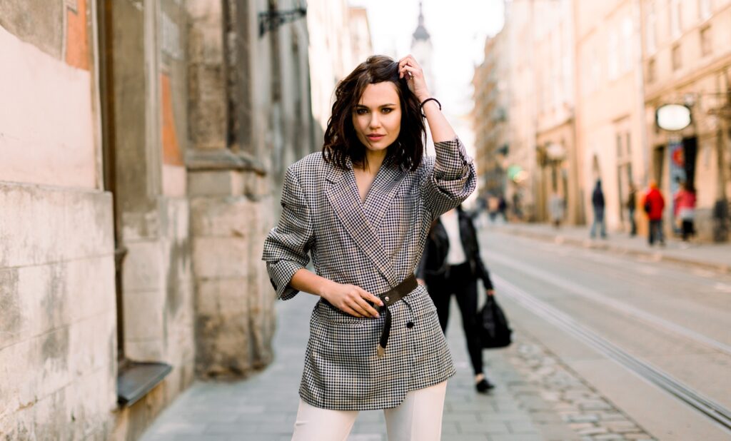 Elegant business woman wearing stylish jacket and white pants